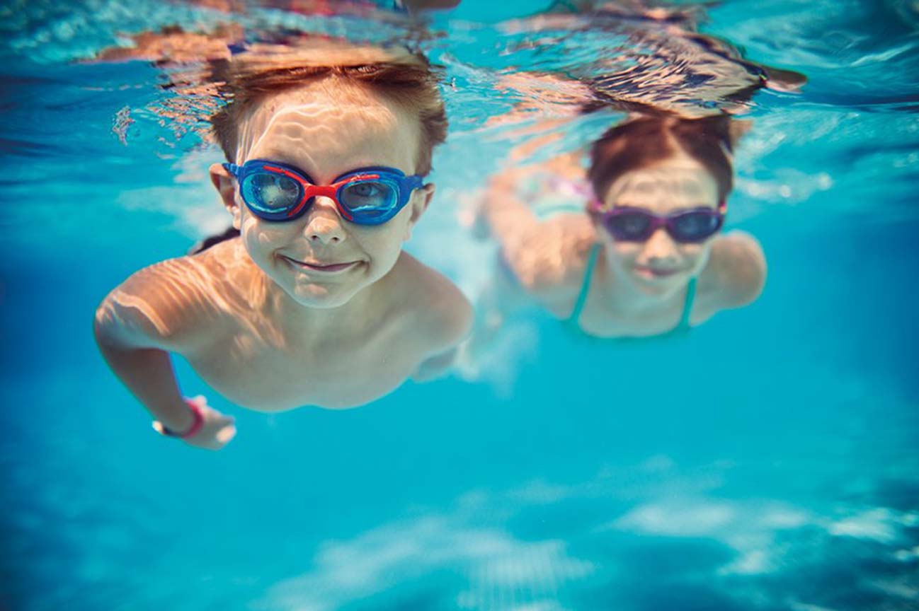 two children swimming underwater