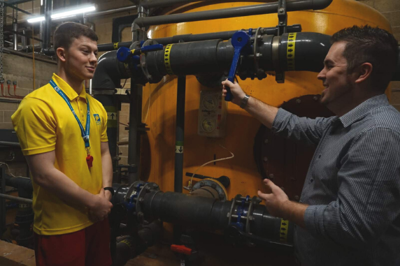 two people talking in a pool plant room